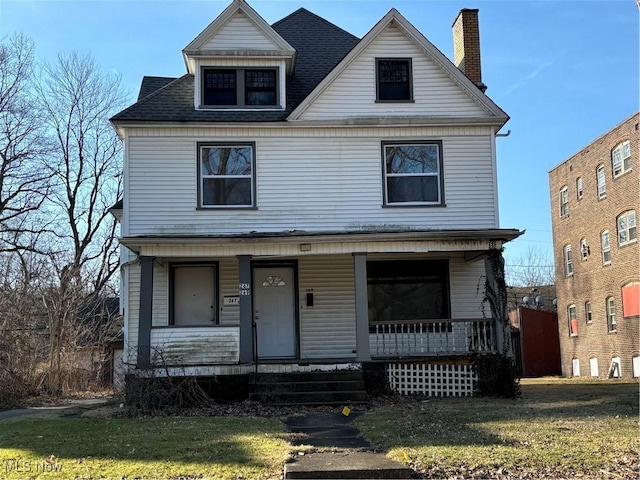 view of front of property with a porch and a front lawn