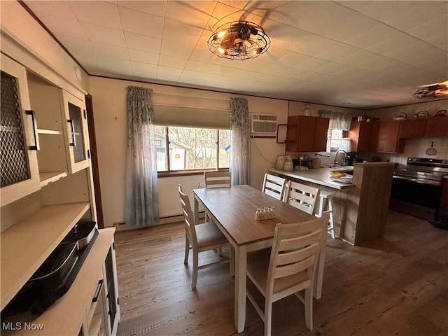 dining space featuring dark wood finished floors and a wall mounted air conditioner