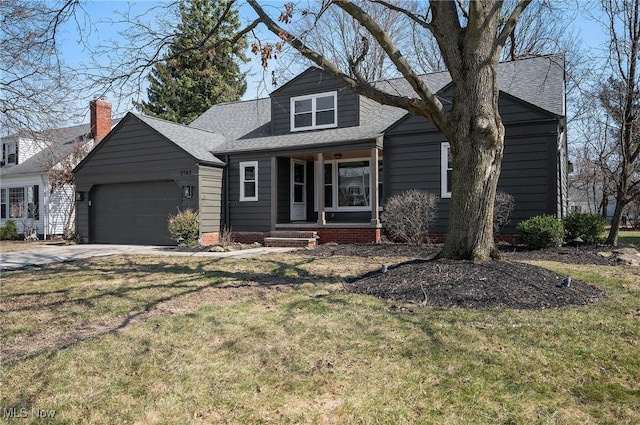 view of front of property with a porch, an attached garage, a shingled roof, a front lawn, and concrete driveway