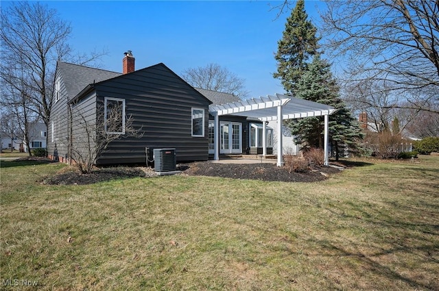 rear view of property featuring a pergola, french doors, a yard, central AC unit, and a chimney