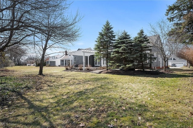 view of yard with french doors and a pergola