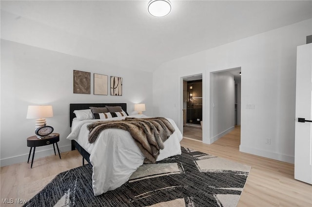 bedroom with baseboards and light wood-style flooring