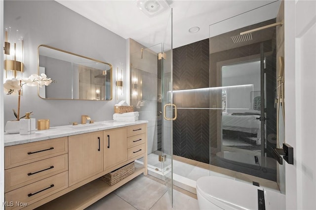 full bath featuring tile patterned floors, vanity, toilet, and a shower stall