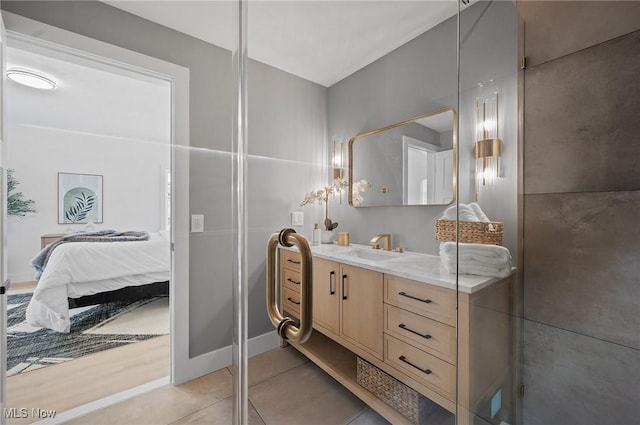 bathroom featuring ensuite bath, tile patterned floors, and vanity