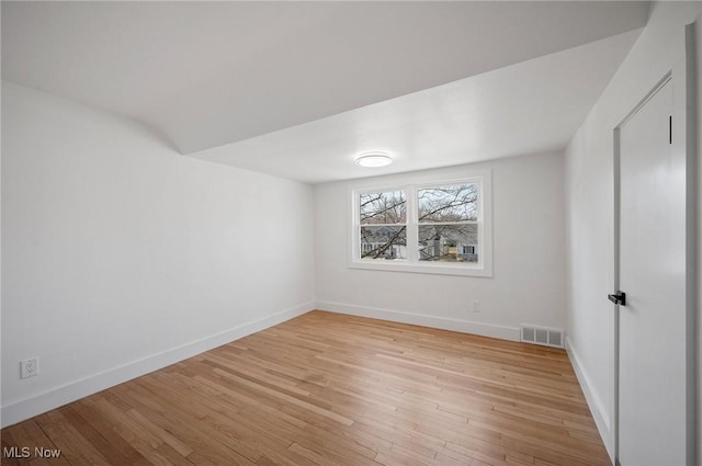 interior space with visible vents, light wood-type flooring, and baseboards