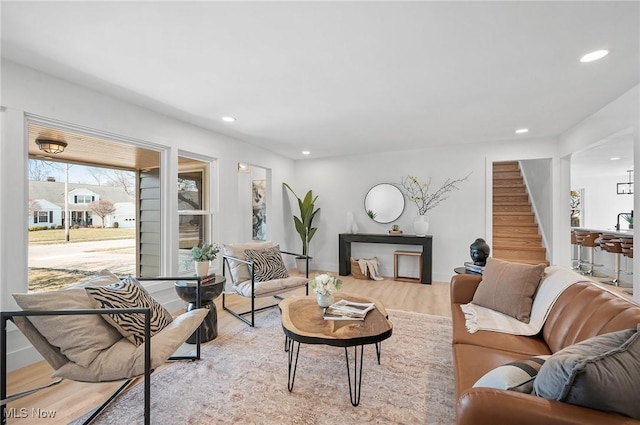 living room featuring recessed lighting, stairway, and wood finished floors