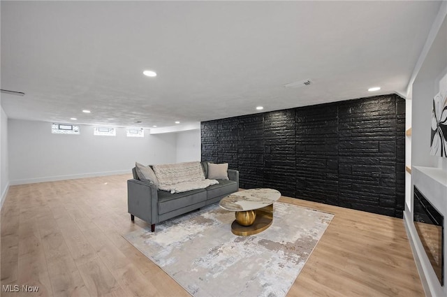 living room with visible vents, recessed lighting, baseboards, and wood finished floors