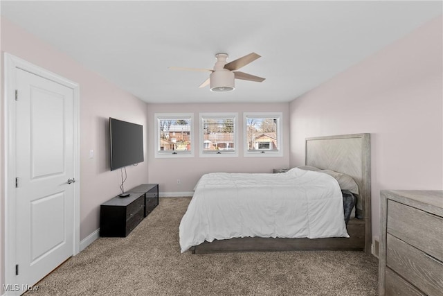 bedroom featuring baseboards, carpet floors, and a ceiling fan