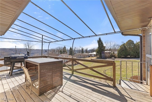 deck featuring grilling area and a lawn