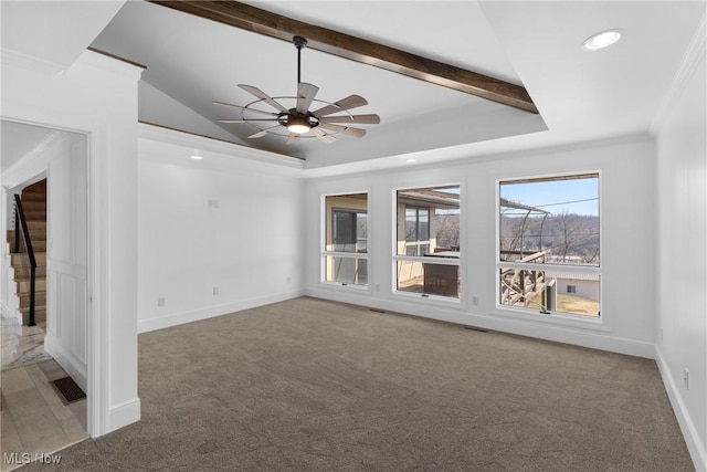 unfurnished living room featuring recessed lighting, a tray ceiling, baseboards, and carpet flooring