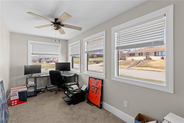 home office featuring baseboards, carpet, and a ceiling fan