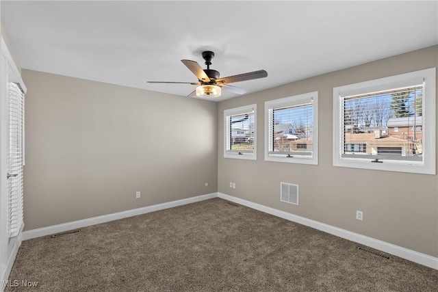 carpeted empty room with visible vents and baseboards