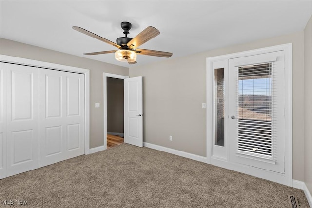 unfurnished bedroom featuring a closet, baseboards, carpet flooring, and access to outside