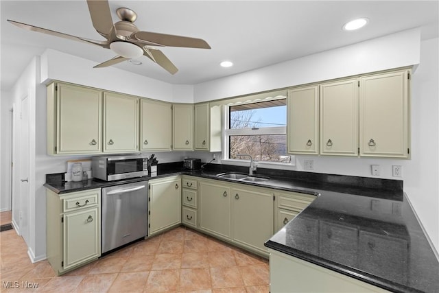 kitchen featuring green cabinetry, stainless steel appliances, and a sink