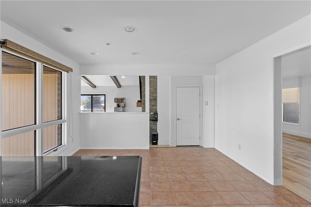 foyer entrance featuring light tile patterned floors, recessed lighting, and baseboards