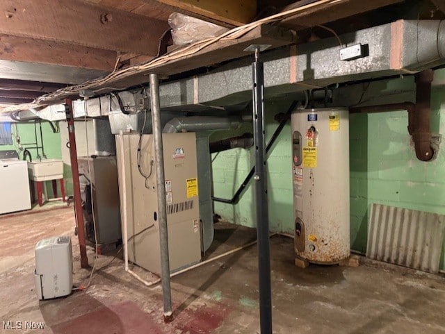 unfinished basement featuring heating unit, washer / clothes dryer, water heater, and a sink