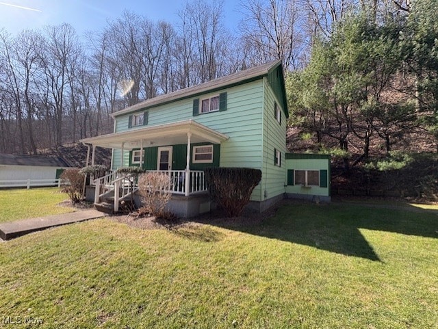 view of front of house with a porch and a front yard