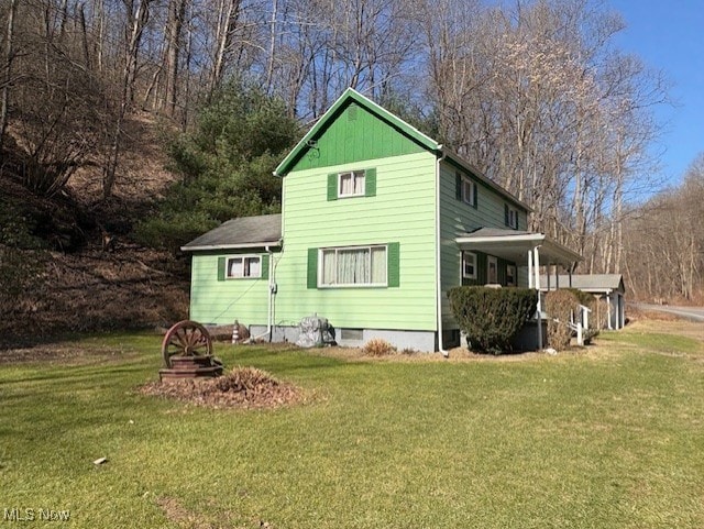 back of house with a lawn