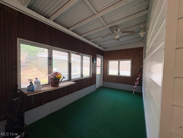 unfurnished sunroom featuring ceiling fan