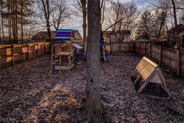 view of yard featuring a playground and a fenced backyard