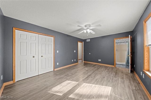 unfurnished bedroom with visible vents, baseboards, and light wood finished floors