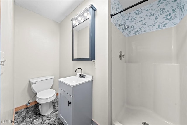 full bath with baseboards, toilet, a stall shower, and vanity