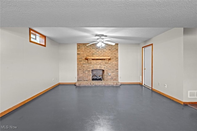 unfurnished living room featuring visible vents, a textured ceiling, a fireplace, baseboards, and concrete flooring