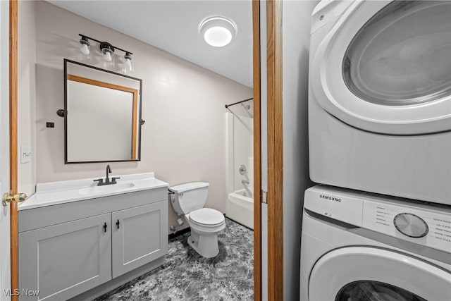 full bathroom with vanity, shower / tub combination, toilet, and stacked washing maching and dryer