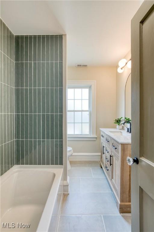 bathroom featuring tile patterned floors, visible vents, toilet, baseboards, and vanity