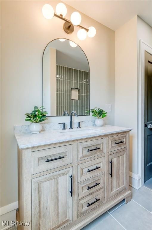 bathroom featuring tile patterned flooring, vanity, and baseboards