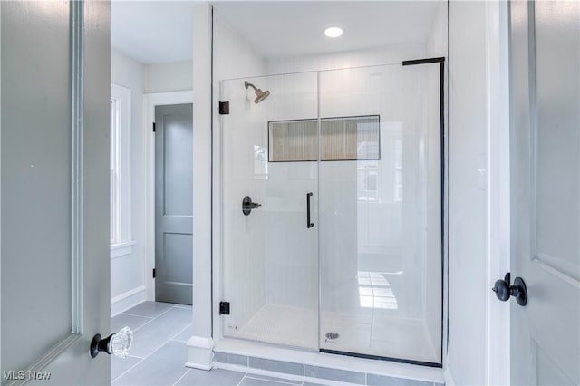 bathroom featuring tile patterned floors and a stall shower