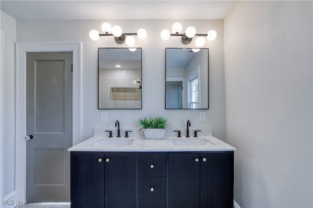 bathroom with a sink and double vanity