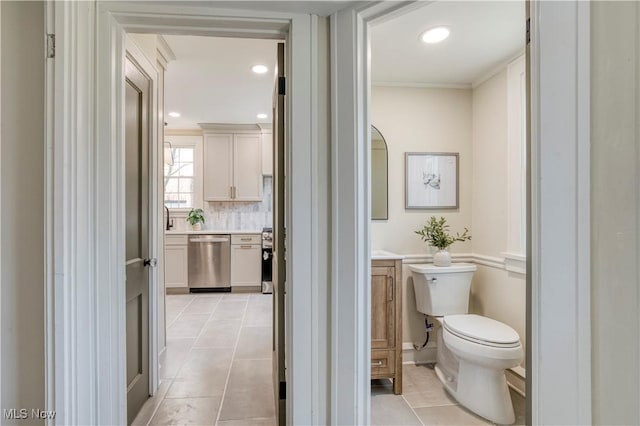 bathroom featuring vanity, recessed lighting, tile patterned floors, toilet, and backsplash