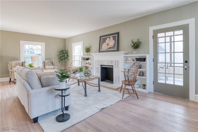 living area with wood finished floors and a fireplace