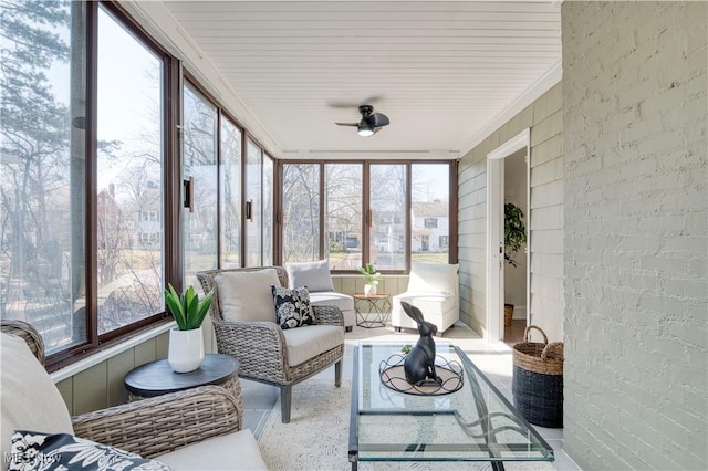 sunroom featuring a ceiling fan