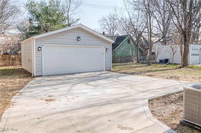 detached garage with central air condition unit and fence