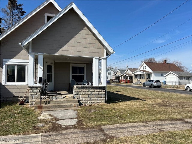 bungalow with a porch and a front yard