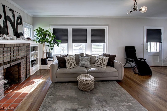 living room with a healthy amount of sunlight, a fireplace, and ornamental molding