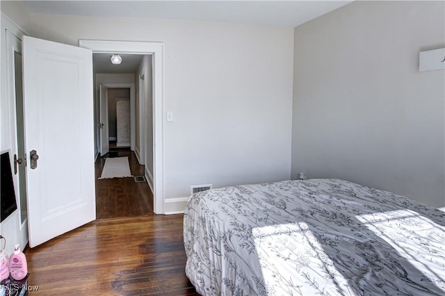 bedroom featuring visible vents and dark wood-style flooring