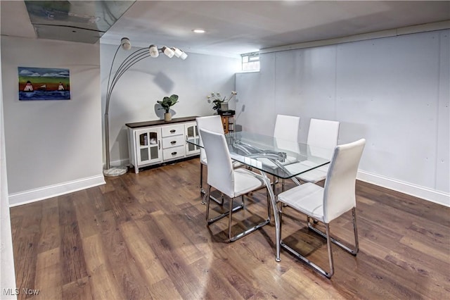 dining area featuring baseboards and wood finished floors