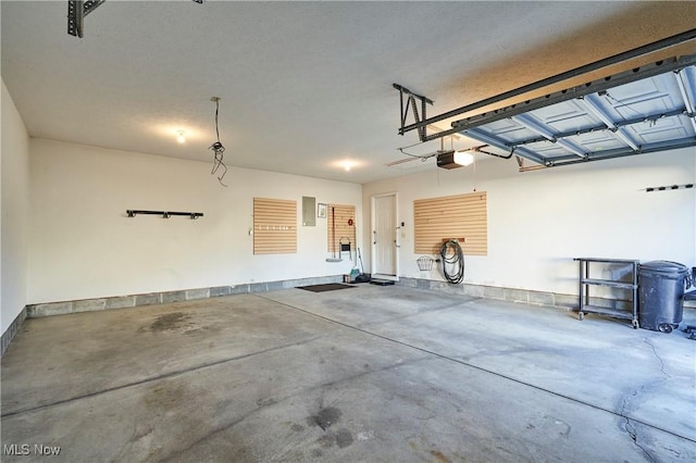 garage featuring electric panel and a garage door opener