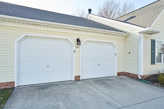 garage with concrete driveway