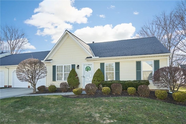 single story home featuring a front yard, concrete driveway, a garage, and a shingled roof