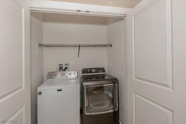 clothes washing area with laundry area and washer and dryer