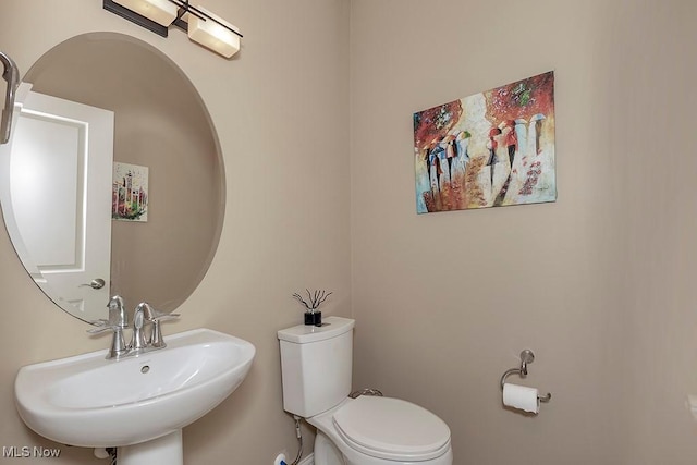 bathroom featuring toilet and a sink