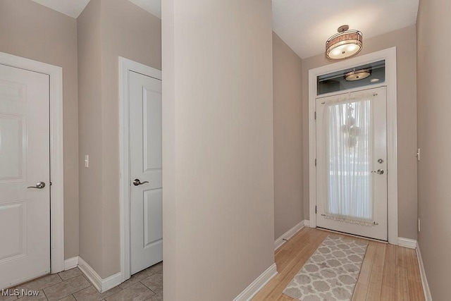 entryway with baseboards and light wood-type flooring