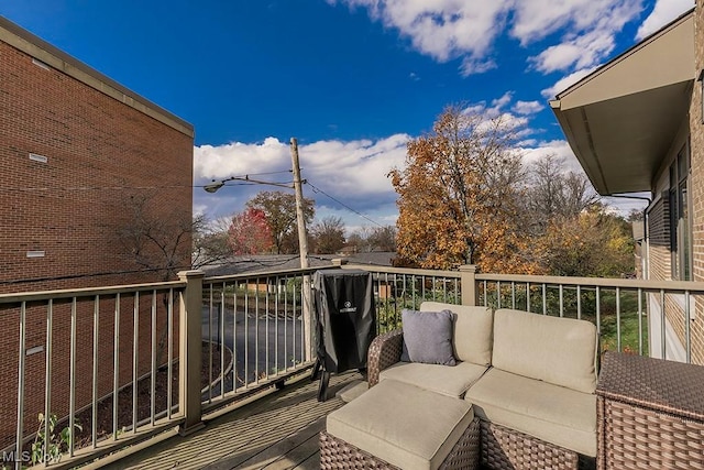 wooden terrace with an outdoor hangout area