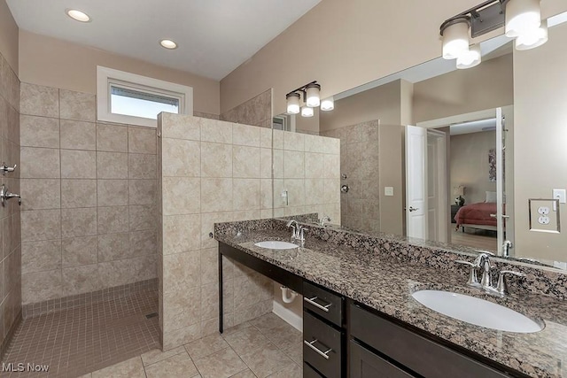 bathroom with ensuite bath, a walk in shower, and a sink