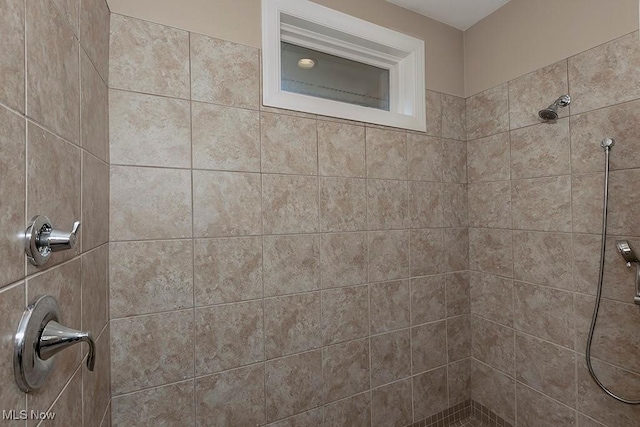 full bathroom with tiled shower