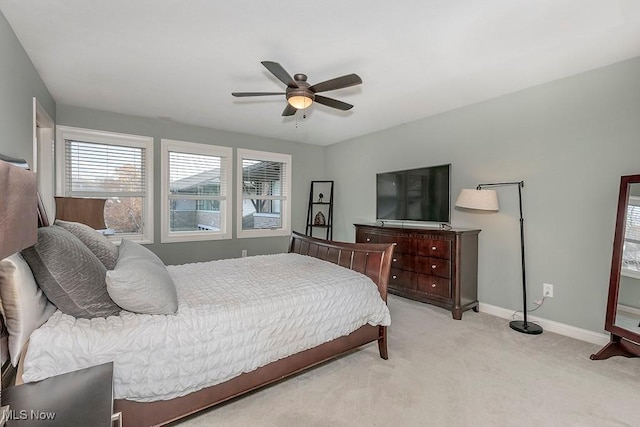 bedroom with baseboards, light colored carpet, and a ceiling fan